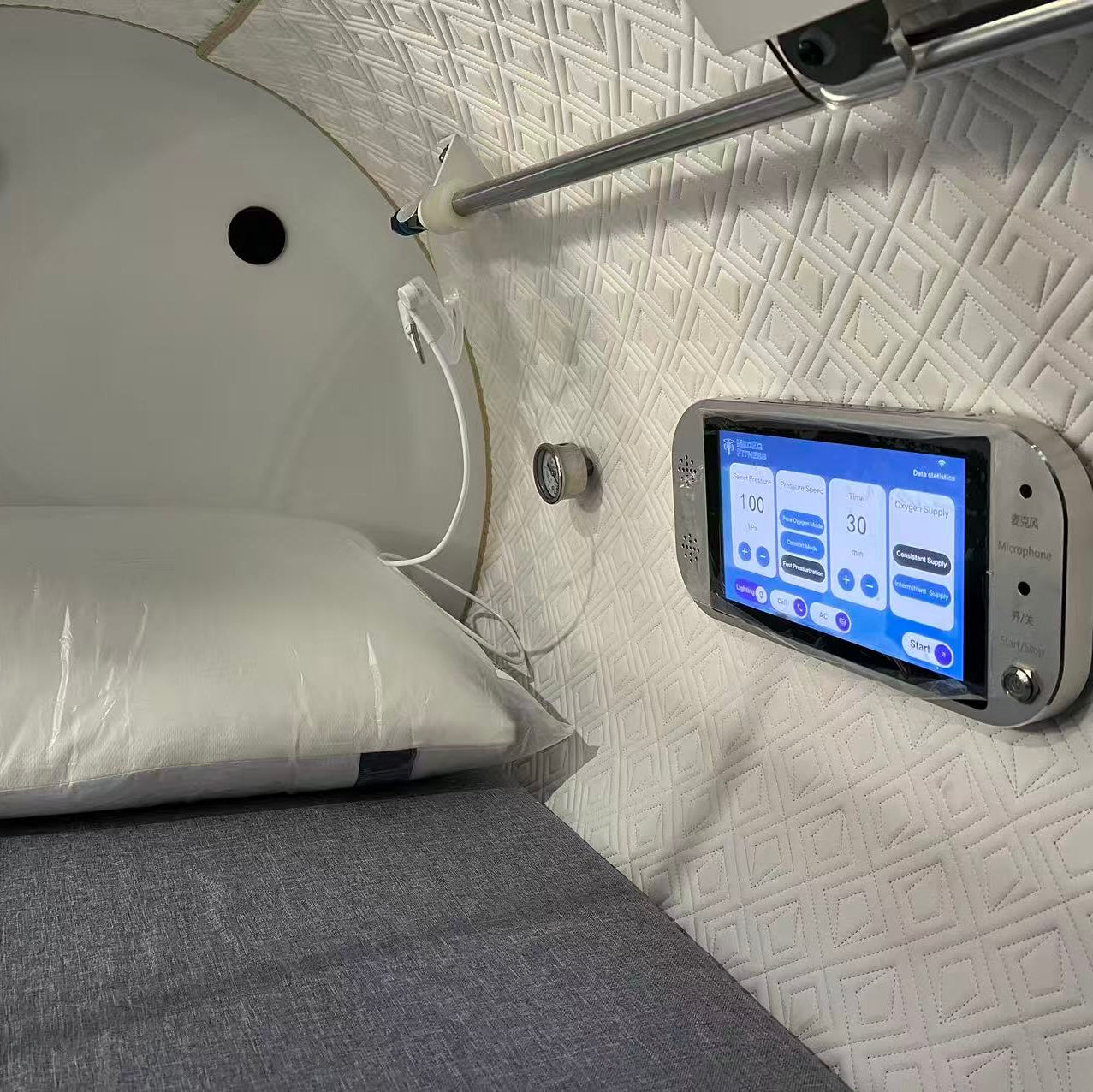 Control panel for a hyperbaric with digital display on a textured wall.