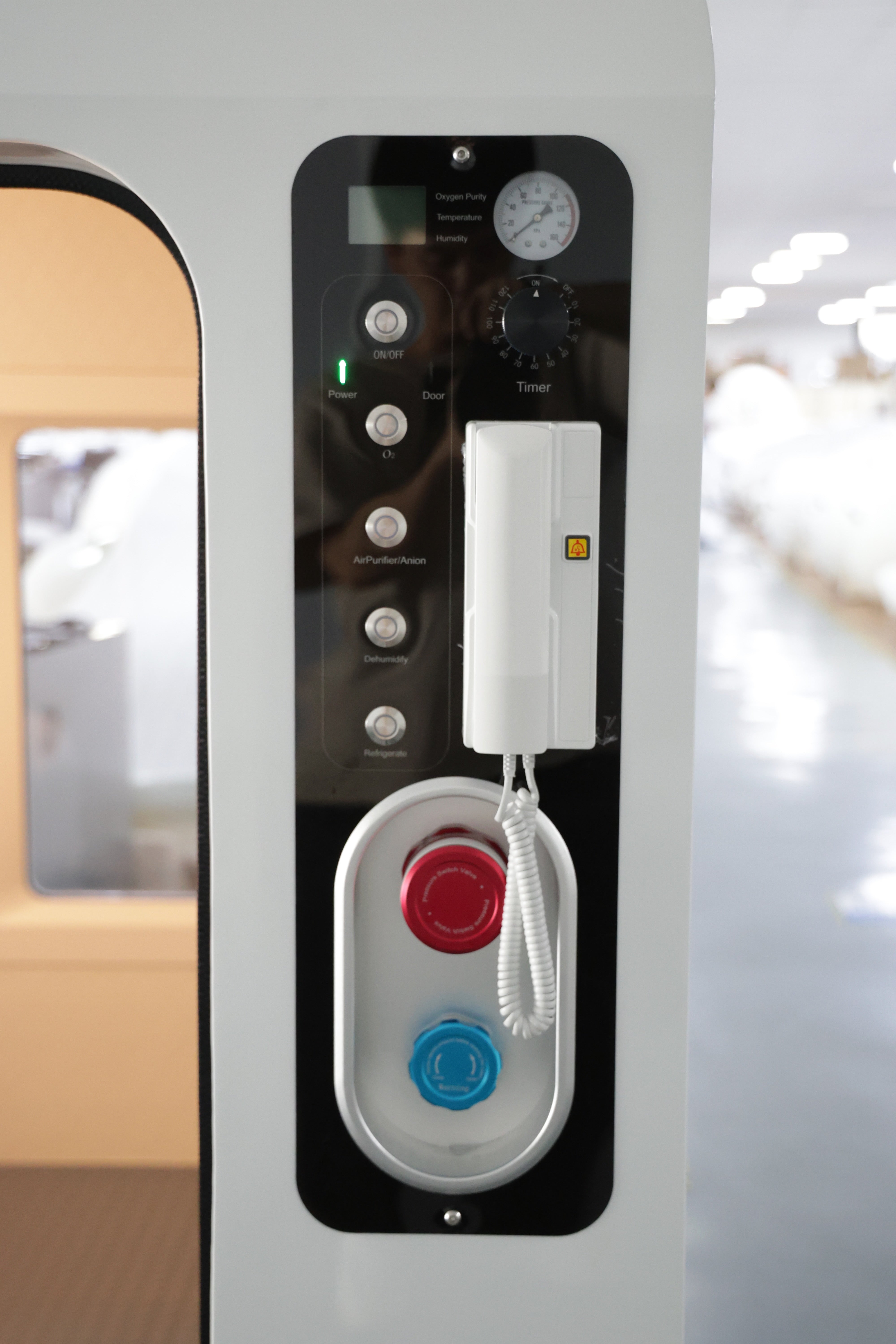 Control panel with buttons and a phone on a vehicle interior dual oxygen concentrator hyperbaric chamber system