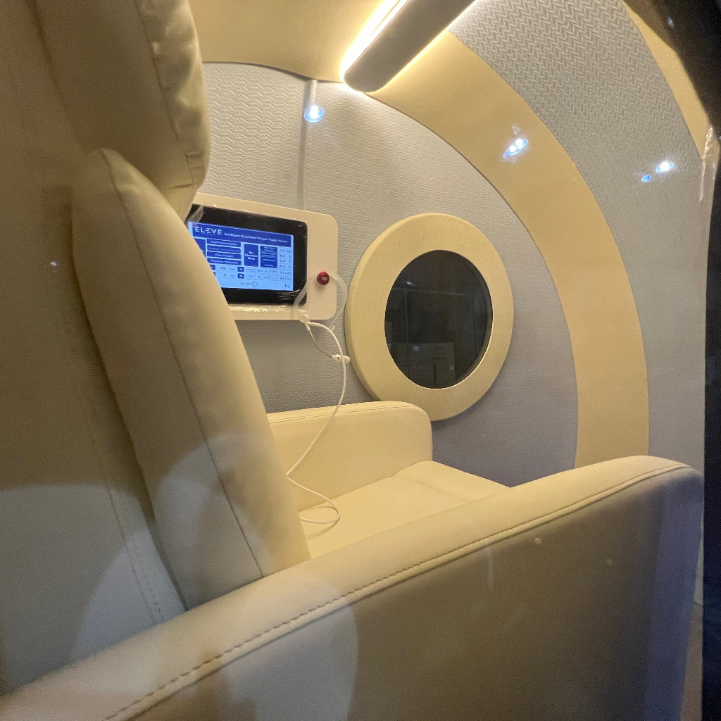 Modern, futuristic chair with a control panel and circular window in a pod hyperbaric chamber
