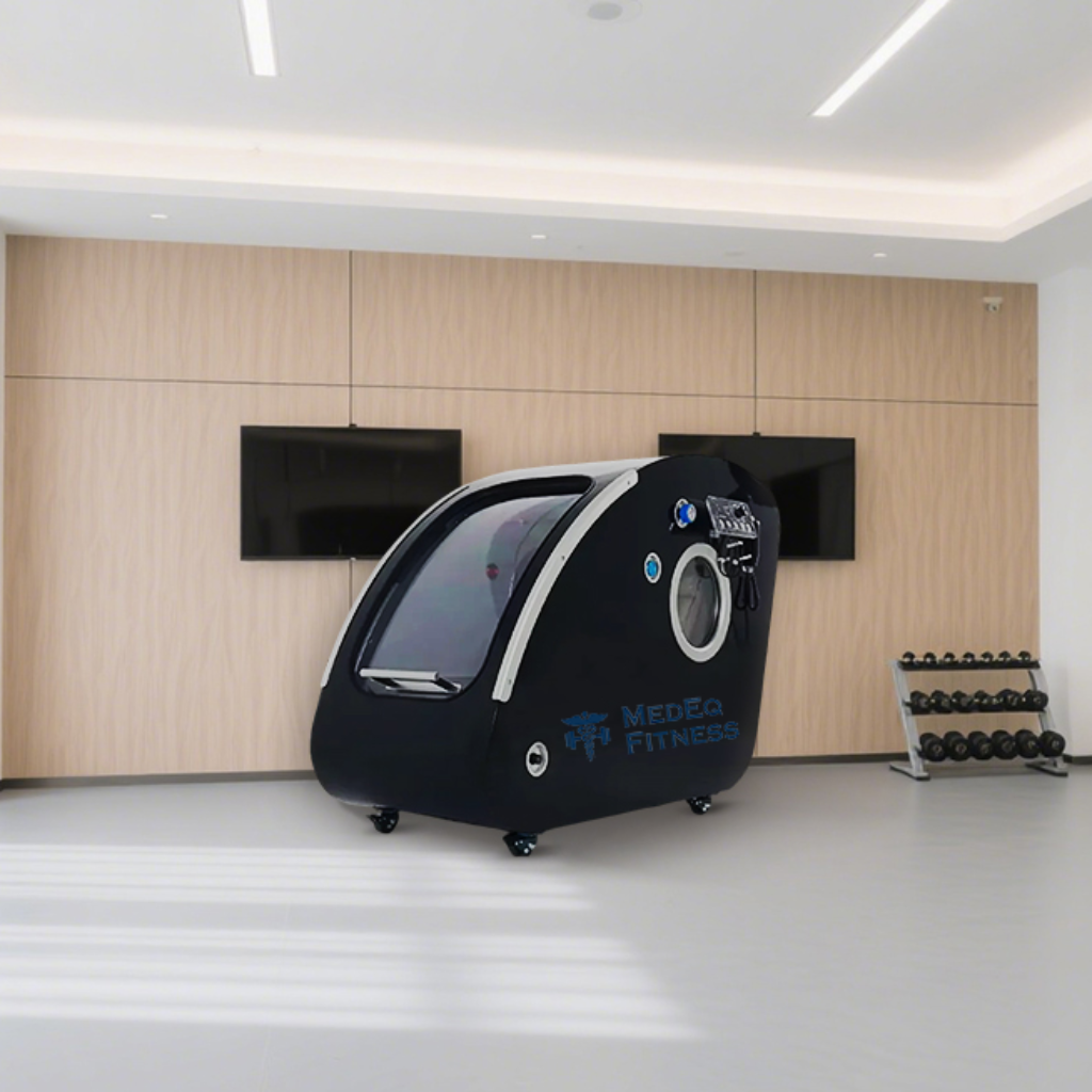 Black exercise bike with screen in a modern gym setting