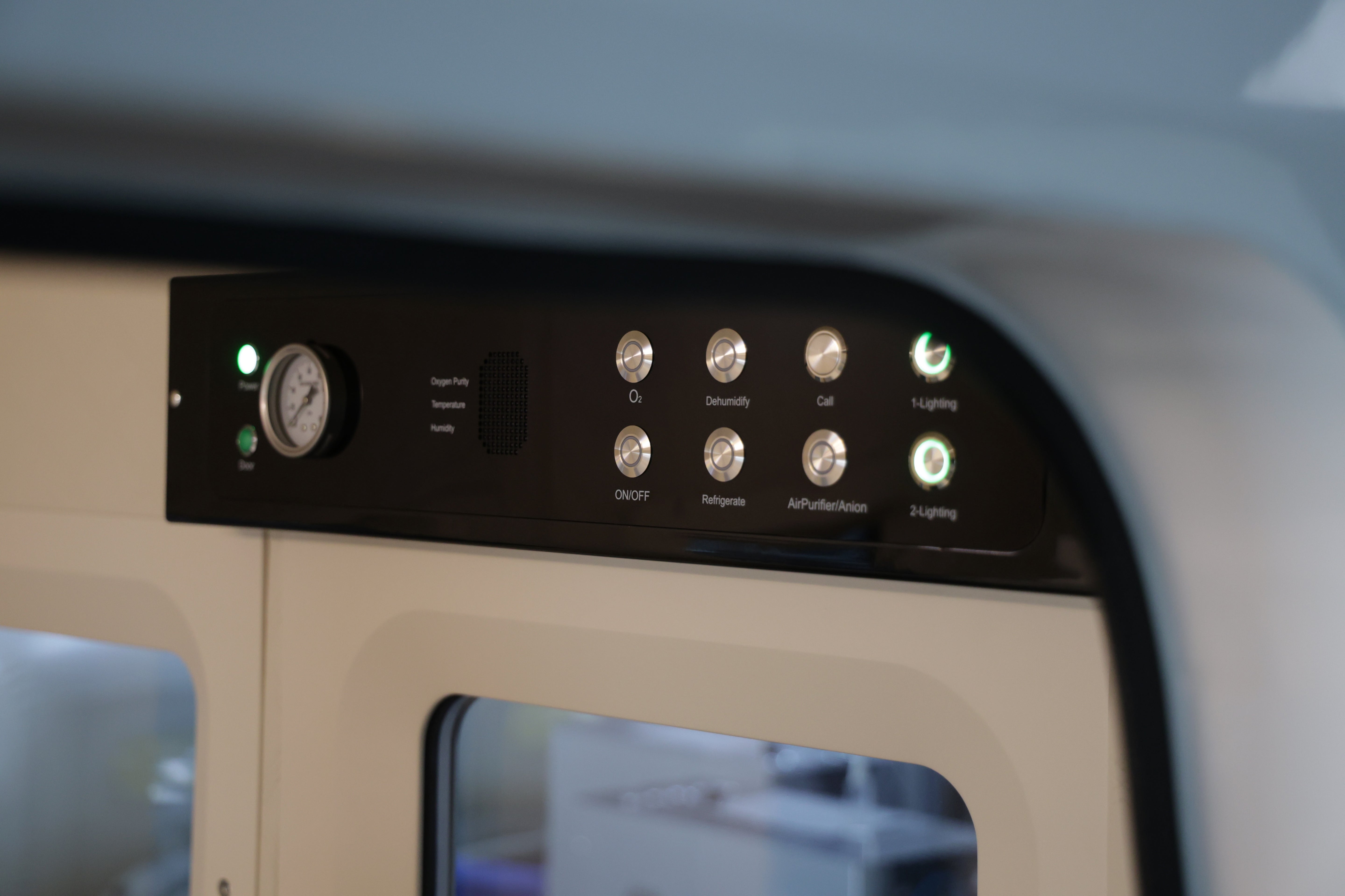 Control panel with buttons and lights on hyperbaric chamber interior