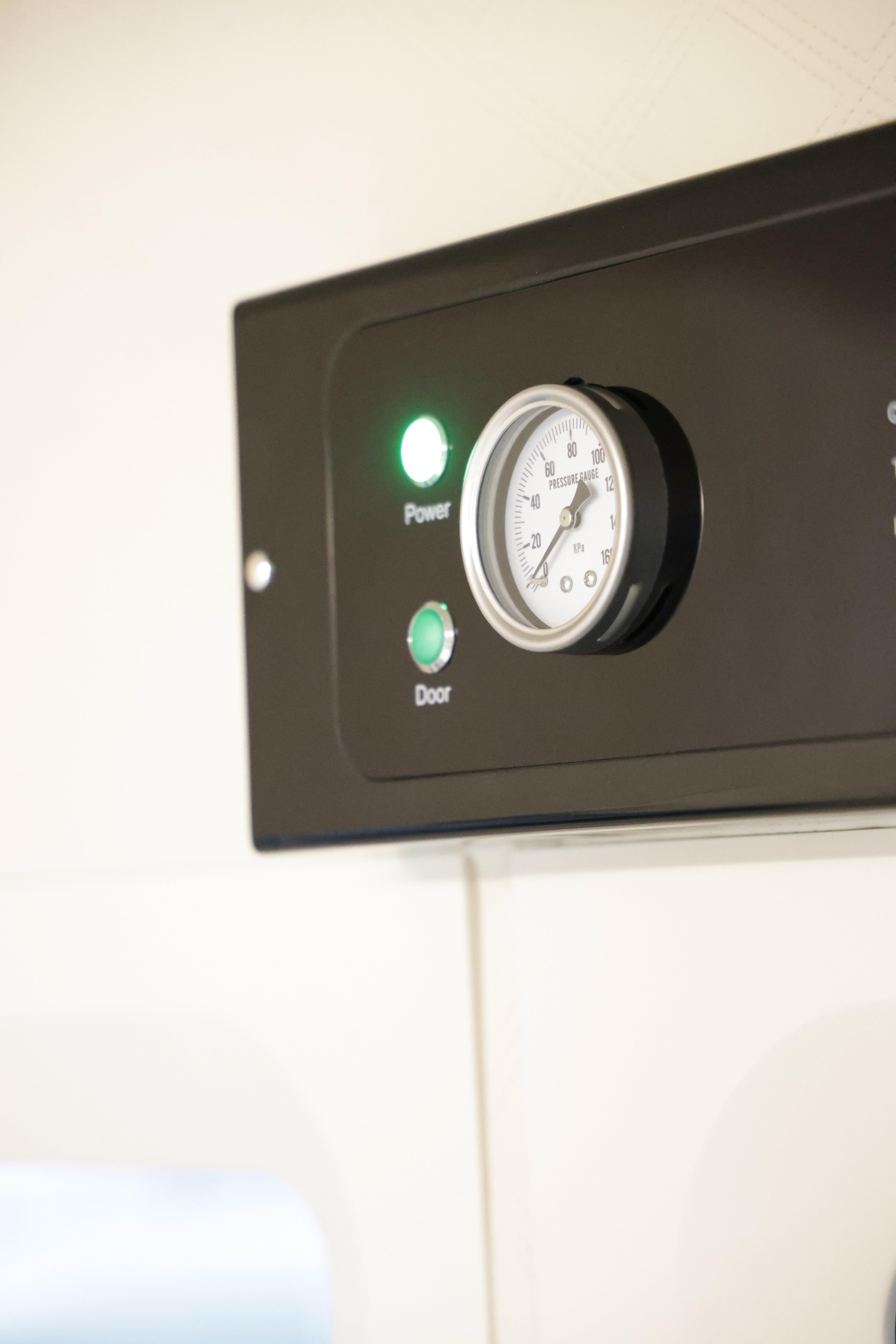 Control panel with a gauge and power indicator light on a white background